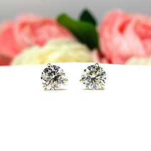 A pair of yellow gold 3-prong martini round 'near colorless' or 'G color' cubic zirconia stud earrings. The earrings are shown on a white background with both earrings facing forward showcasing the crisp faceting and clear clarity of the czs.