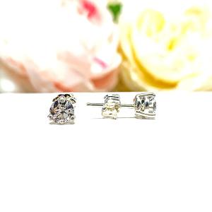A pair of silver 3-prong basket martini round 'near colorless' or 'G color' cubic zirconia stud earrings. The earrings are shown on a white background with the left earring facing forward showcasing the crisp faceting and clear clarity of the czs, and the right earring facing to the right displaying the center post and butterfly friction clasp.
