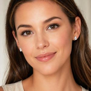 A woman wearing 9x6mm pear-cut cz 3-prong stud earrings. Model image for size and styling reference — not a photo of the actual earrings.