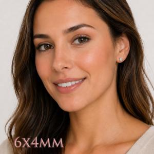 A woman wearing 6x4mm oval cz sterling silver stud earrings. Model image for size and styling reference — not a photo of the actual earrings.