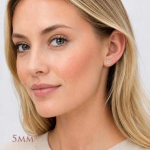 A woman wearing a pair of silver basket stud earrings set with 5mm light yellow old european cut round cubic zirconias.