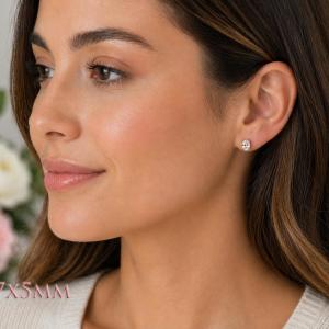 A woman wearing 7x5mm oval cz gold stud earrings. Model image for size and styling reference — not a photo of the actual earrings.