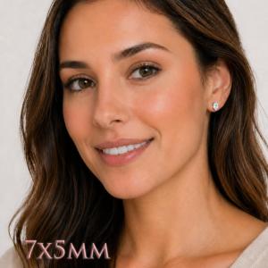 A woman wearing 7x5mm oval cz sterling silver stud earrings. Model image for size and styling reference — not a photo of the actual earrings.