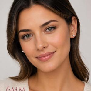 A woman wearing a pair of silver stud earrings with 6mm clear round white topaz gemstones. Model image for size and styling reference — not a photo of the actual earrings.