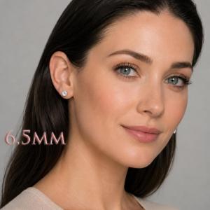 A woman wearing 6.5mm mixed-brilliant round-cut lab white sapphire sterling silver stud earrings. Model image for size and styling reference — not a photo of the actual earrings.