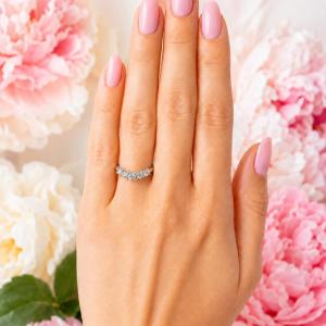 Sterling silver curved band set with 3mm round near colorless czs shown worn on a woman's hand. Model image for size and styling reference — not a photo of the actual ring