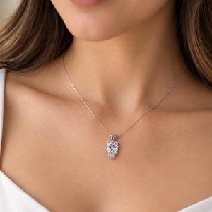 A woman wearing a 12x8mm inverted pear cz sterling silver pendant necklace. Model image for size and styling reference — not a photo of the actual necklace.