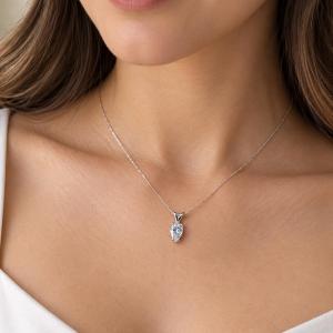 A woman wearing a 9x6mm inverted pear cz sterling silver pendant necklace. Model image for size and styling reference — not a photo of the actual necklace.