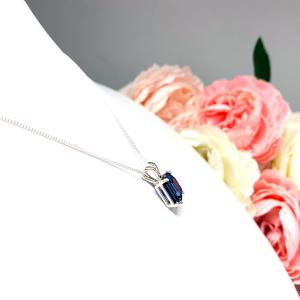 Sterling silver necklace featuring a 10x8mm emerald-cut lab-created blue sapphire pendant in a 4-prong setting.