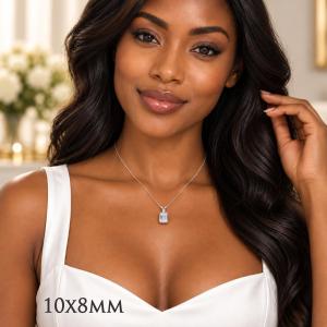 A woman wearing a sterling silver necklace featuring a 10x8mm emerald-cut lab-created white sapphire pendant in a 4-prong setting. Model image for size and styling reference — not a photo of the actual necklace.