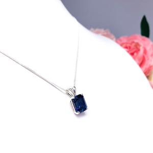 Sterling silver necklace featuring a 10x8mm emerald-cut lab-created blue sapphire pendant in a 4-prong setting.