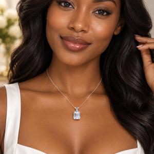 A woman wearing a sterling silver necklace featuring a 12x10mm emerald-cut lab-created white sapphire pendant in a 4-prong setting. Model image for size and styling reference — not a photo of the actual necklace.