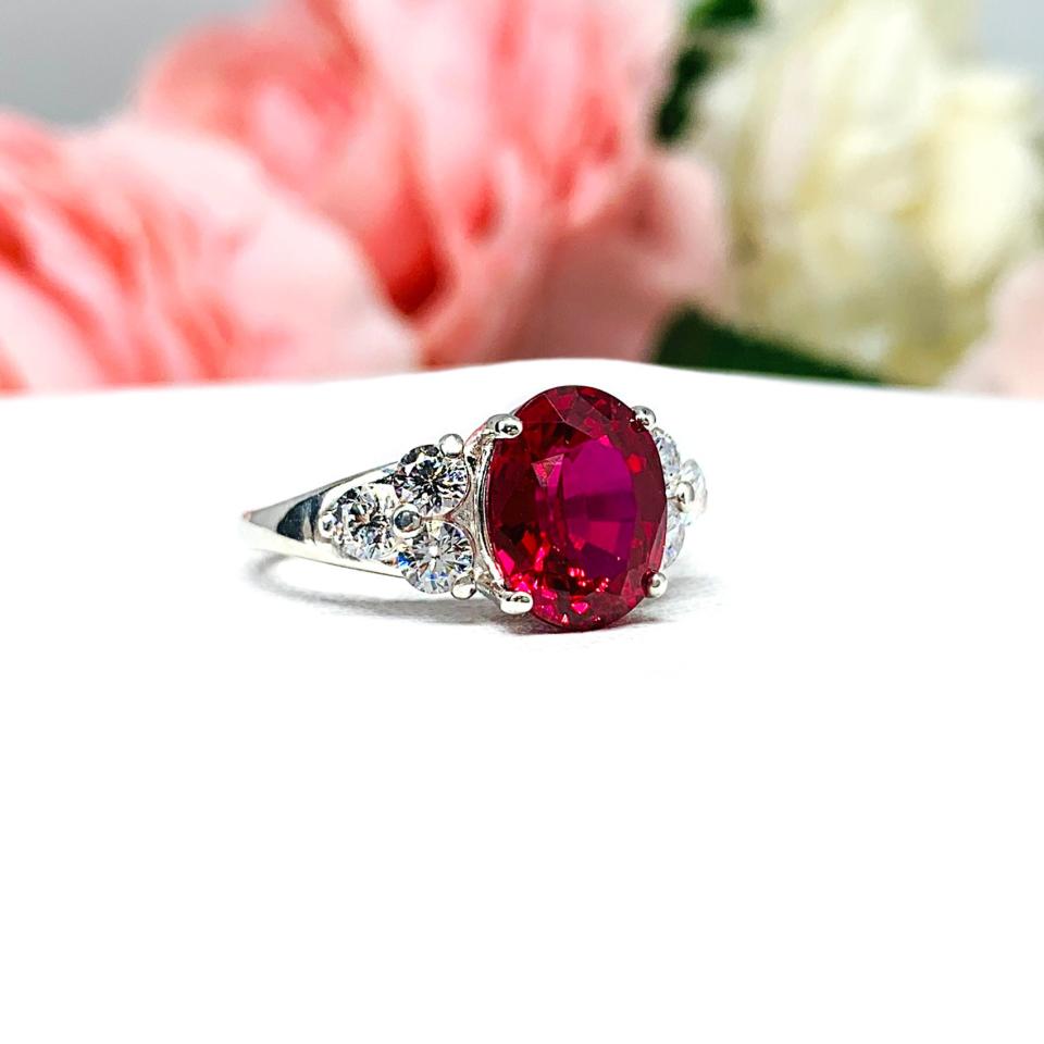 Lab Created Ruby Oval Ring Round CZ Accented Sterling Silver