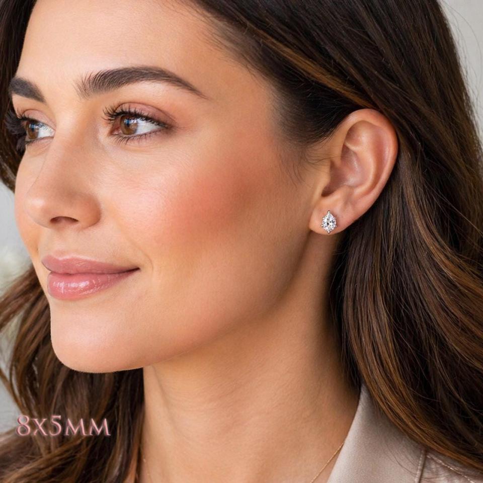 A woman wearing 8x5mm pear-cut cz 6-prong stud earrings. Model image for size and styling reference — not a photo of the actual earrings.