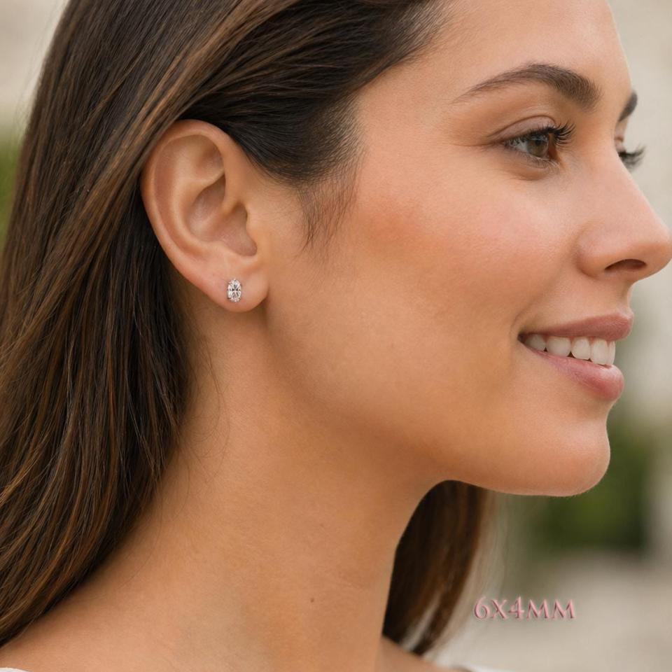 A woman wearing 6x4mm oval cz 6-prong stud earrings. Model image for size and styling reference — not a photo of the actual earrings.