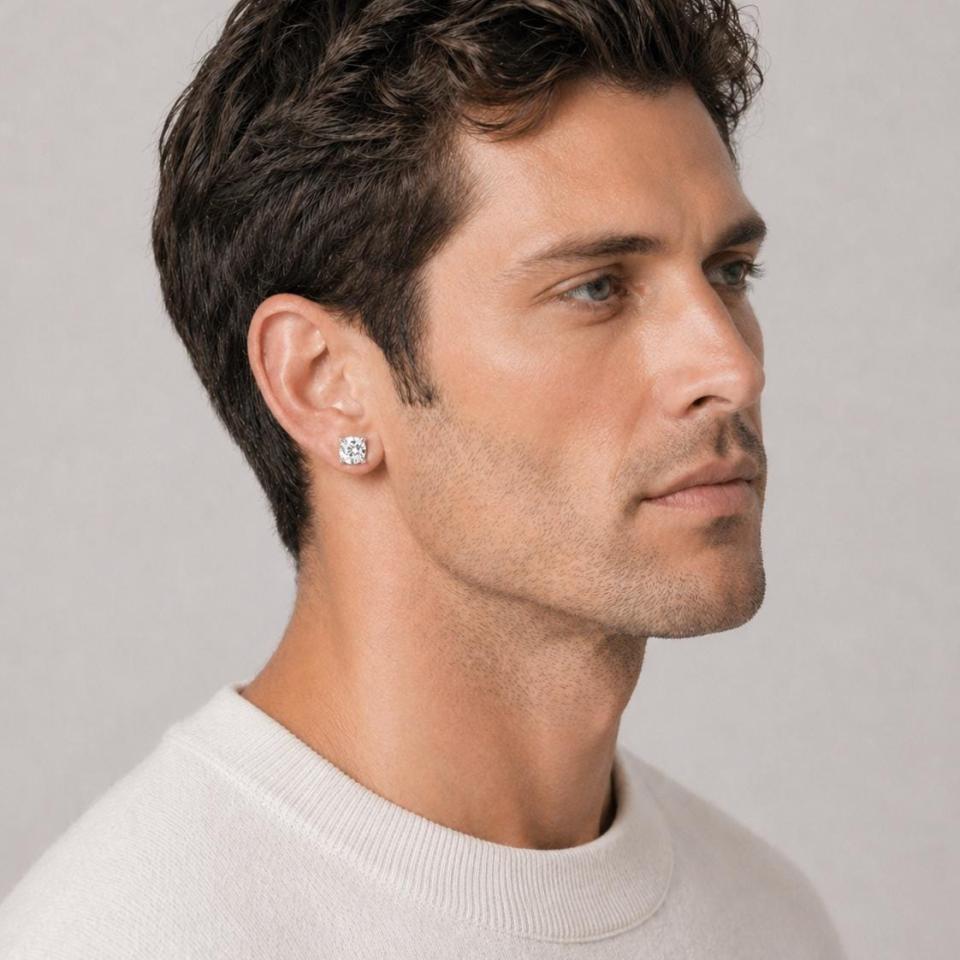 A man wearing silver stud earrings with very light yellow or "near colorless" old mine cut cubic zirconia stones. Model image for size and styling reference — not a photo of the actual earrings.