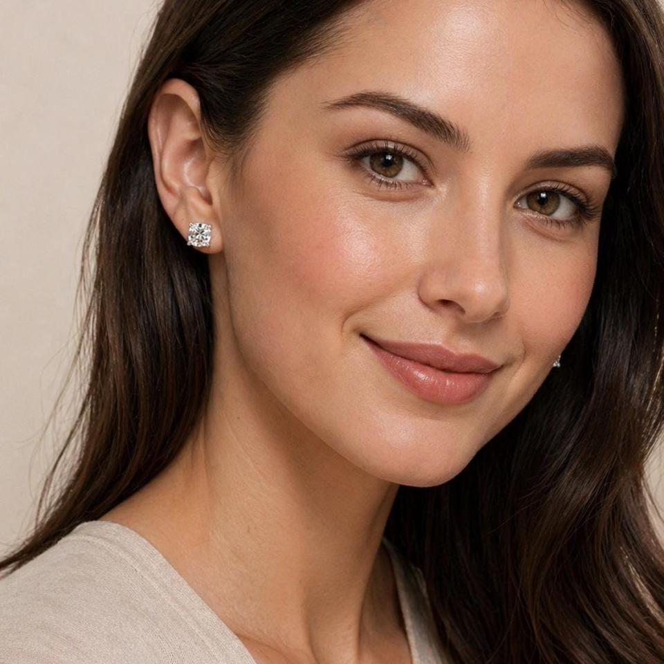 A woman wearing silver stud earrings with very light yellow or "near colorless" old mine cut cubic zirconia stones. Model image for size and styling reference — not a photo of the actual earrings.