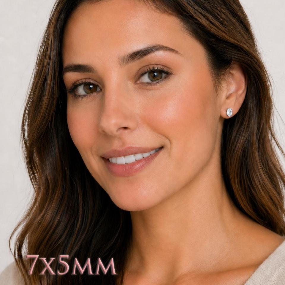 A woman wearing 7x5mm oval cz sterling silver stud earrings. Model image for size and styling reference — not a photo of the actual earrings.