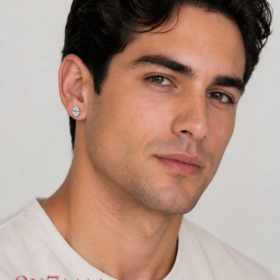 A man wearing 9x7mm oval cz sterling silver stud earrings. Model image for size and styling reference — not a photo of the actual earrings.