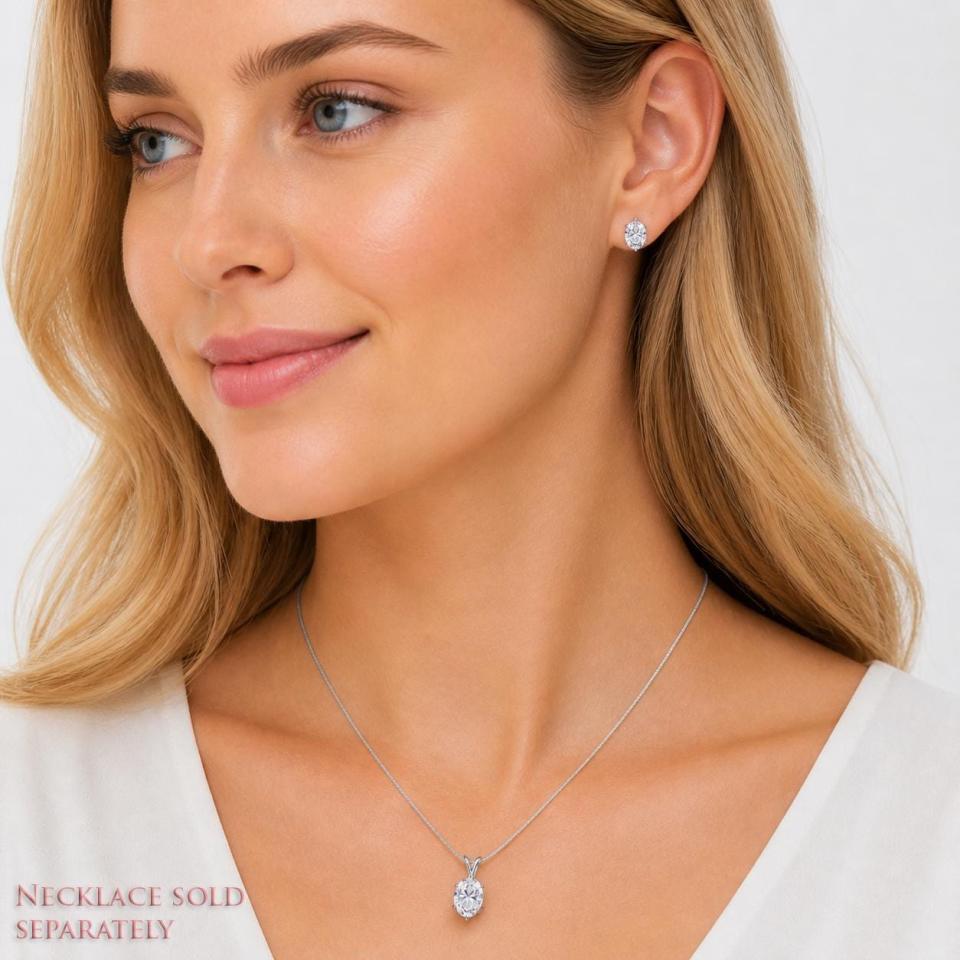 Woman wearing oval cz stud earrings and pendant necklace (sold separately). Model image for size and styling reference — not a photo of the actual earrings.