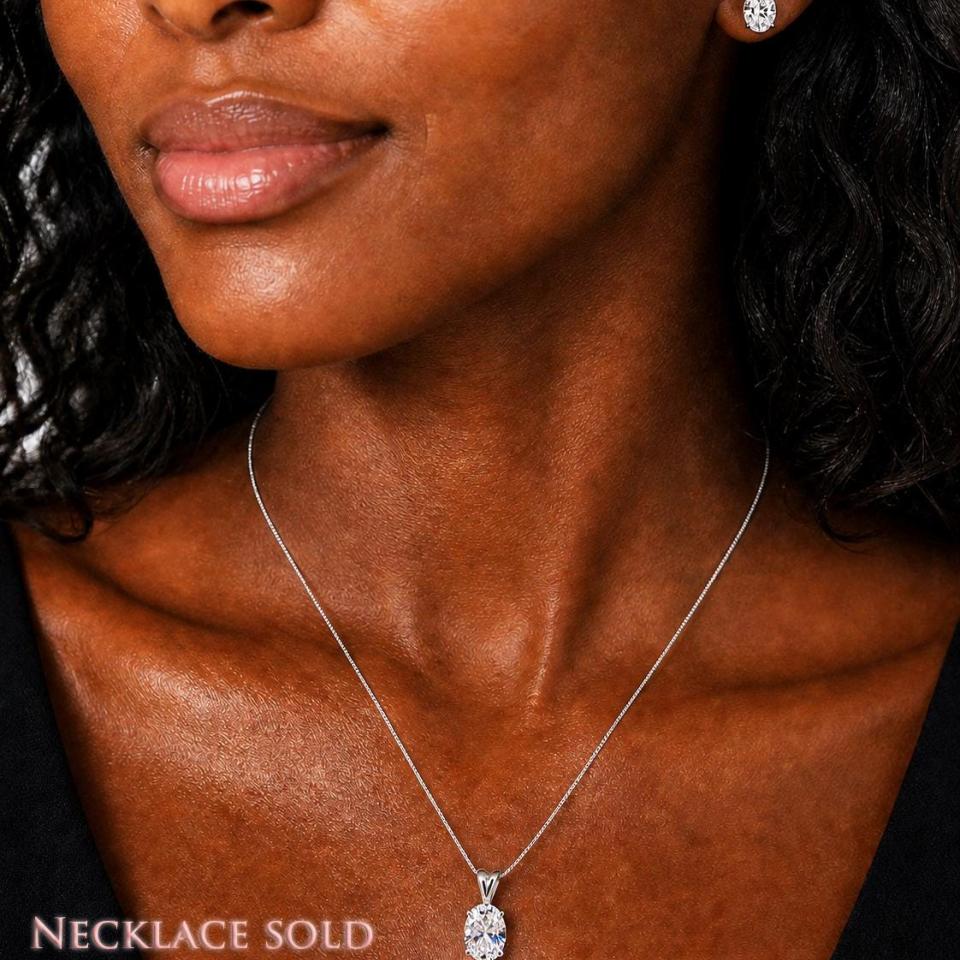 Woman wearing oval cz stud earrings and pendant necklace (sold separately). Model image for size and styling reference — not a photo of the actual earrings.