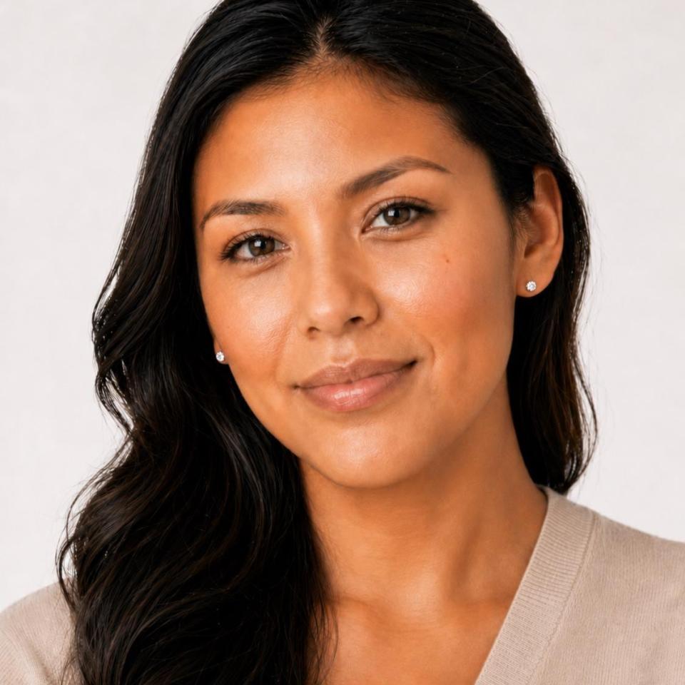 A woman wearing 4.5mm mixed-brilliant round-cut lab white sapphire sterling silver stud earrings. Model image for size and styling reference — not a photo of the actual earrings.