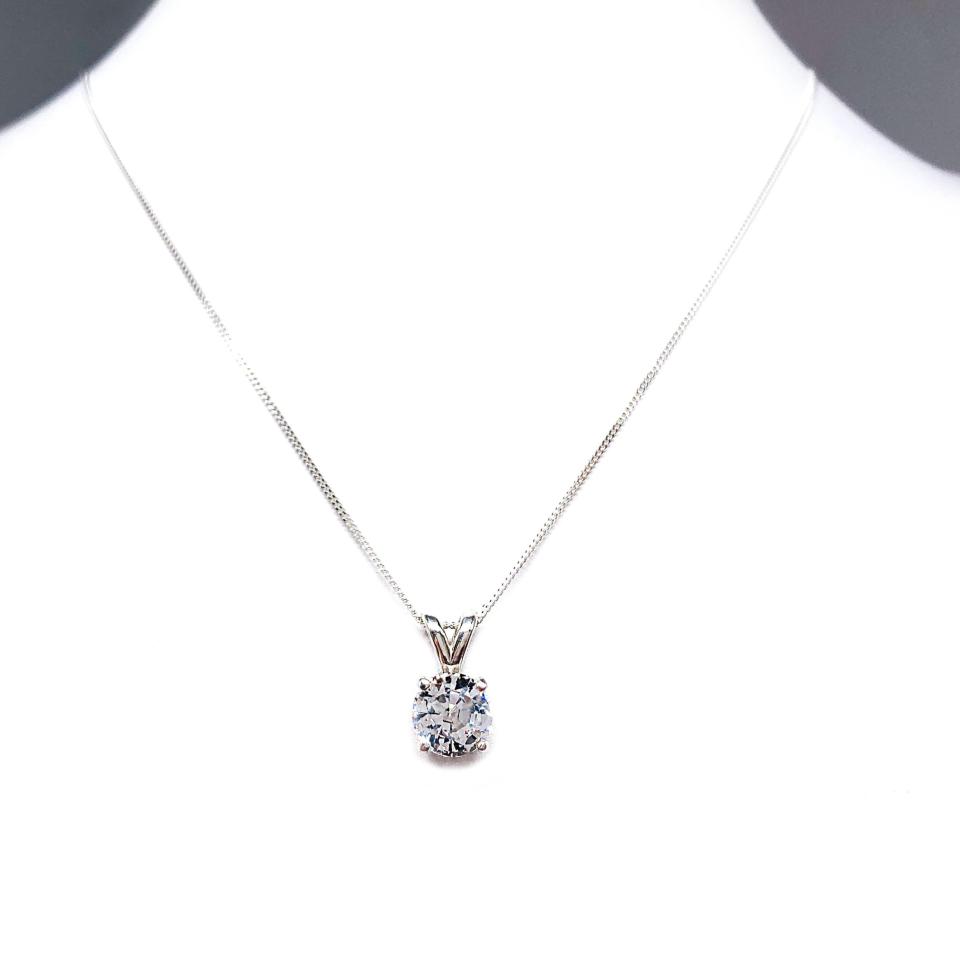 Sterling silver necklace featuring a round mixed-brilliant cut lab-created white sapphire pendant in a 4-prong setting, available in five sizes.