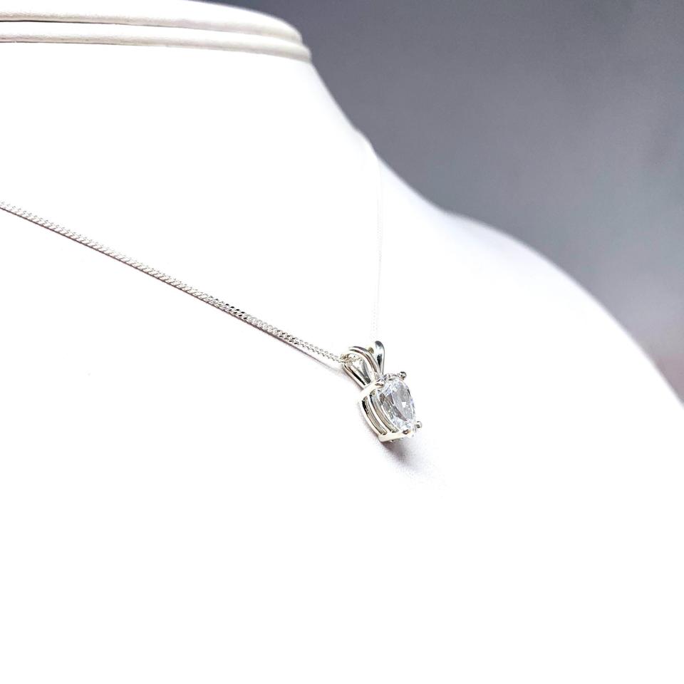 Sterling silver necklace featuring a pear-cut cubic zirconia with brilliant sparkle. The teardrop-shaped stone is inverted, creating a unique and modern look.