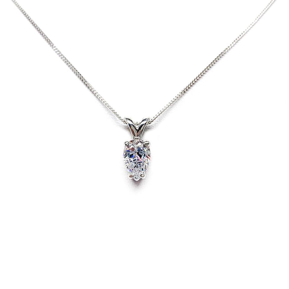 Sterling silver necklace featuring a pear-cut cubic zirconia with brilliant sparkle. The teardrop-shaped stone is inverted, creating a unique and modern look.
