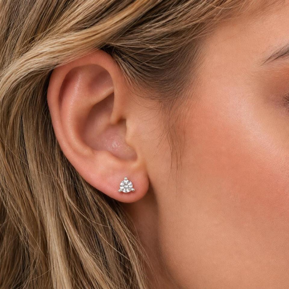 A woman wearing 6mm old european cut cz martini stud earrings. Model image for size and styling reference — not a photo of the actual earrings.