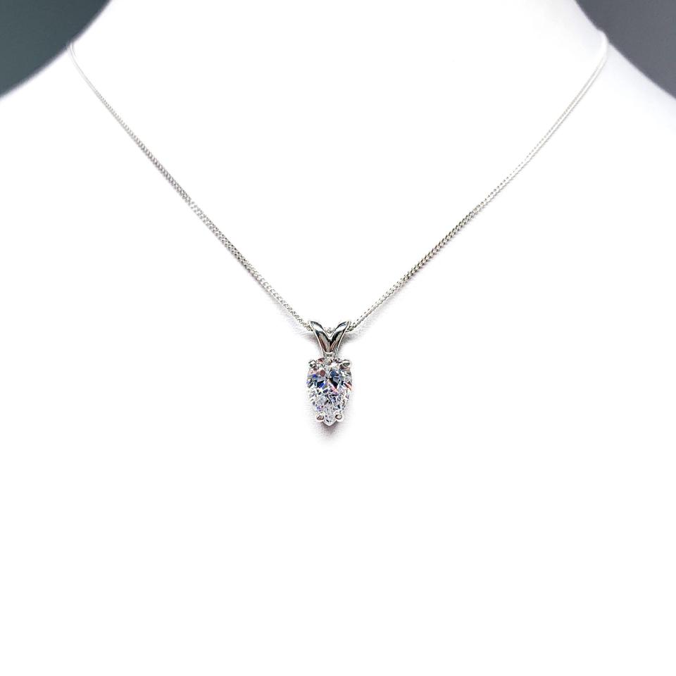 Sterling silver necklace featuring a pear-cut cubic zirconia with brilliant sparkle. The teardrop-shaped stone is inverted, creating a unique and modern look.