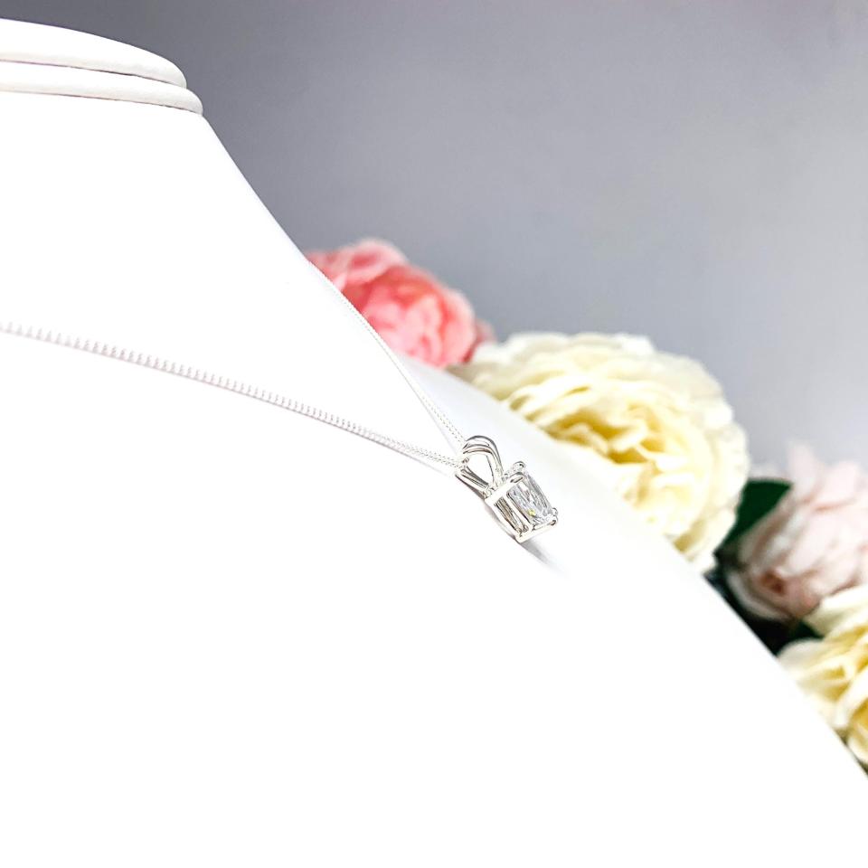Sterling silver necklace featuring a pear-cut cubic zirconia with brilliant sparkle. The teardrop-shaped stone is inverted, creating a unique and modern look.