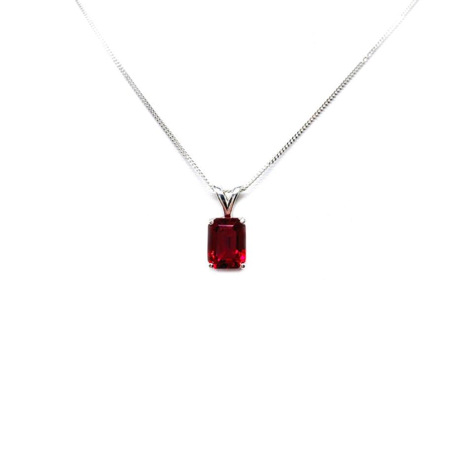 Sterling silver necklace featuring a 9x7mm emerald-cut lab-created ruby pendant in a 4-prong setting.