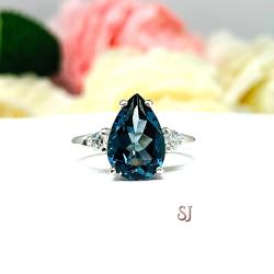 London Blue Topaz Pear Moissanite Ring - Sterling silver setting- Round moissanite side stones