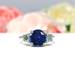 Lab Blue Sapphire Round 3-Stone Ring – Blue Moissanite Accents, Sterling Silver