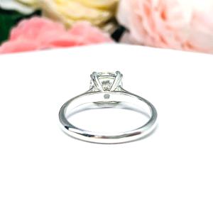 Close-up of a sterling silver cathedral-style engagement ring featuring an 8mm near colorless cushion cut cubic zirconia center stone. The ring is shown facing forward, showcasing the brilliant faceting of the center stone and split prongs.