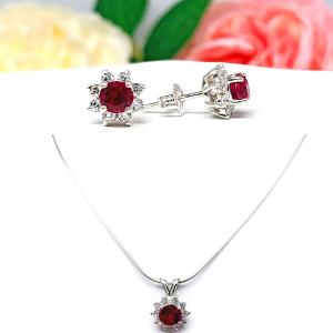 A photo composite featuring a sterling silver necklace with a pendant set with a round vivid deep red lab ruby surrounded by small czs in a halo. Matching stud earrings appear above the necklace. The necklace and earrings are both on a white background. The text 'EARRINGS SOLD SEPARATELY' is at the bottom of the image. The text 'SJ' is at the bottom right of the image.