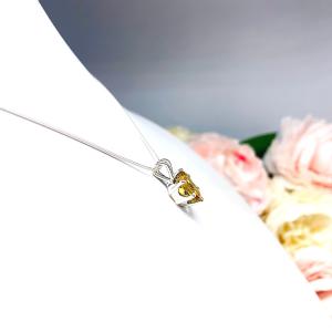 Sterling silver necklace with a 10x8mm oval-cut golden citrine pendant in a 6-prong setting, displayed against a white background.