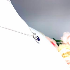 Sterling silver necklace featuring a natural African amethyst pendant in an oval cut, secured by a four-prong setting and displayed on a sterling silver chain.