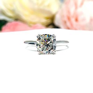 Close-up of a sterling silver cathedral-style engagement ring featuring an 8mm near colorless cushion cut cubic zirconia center stone. The ring is shown facing forward, showcasing the brilliant faceting of the center stone and split prongs.