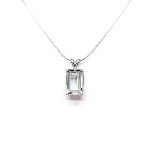 Close-up of an emerald-cut white topaz pendant necklace featuring a faceted natural gemstone in a sterling silver prong setting, suspended from a delicate sterling chain. Available in four stone sizes.