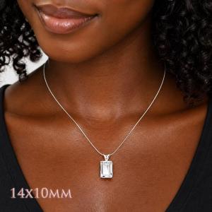 A woman wearing a 14x10mm emerald cut white topaz sterling silver pendant necklace. Model image for size and styling reference — not a photo of the actual necklace.