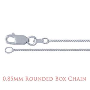 A close-up image of a delicate silver chain with a lobster clasp closure. The chain features a rounded box link design, where each small, square-shaped link has softly curved edges that create a smooth, reflective surface. The overall appearance is sleek and polished, highlighting the fine craftsmanship and subtle shine of the metal. Text at the bottom of the image reads “0.85mm Rounded Box Chain” in a soft rose-colored font.