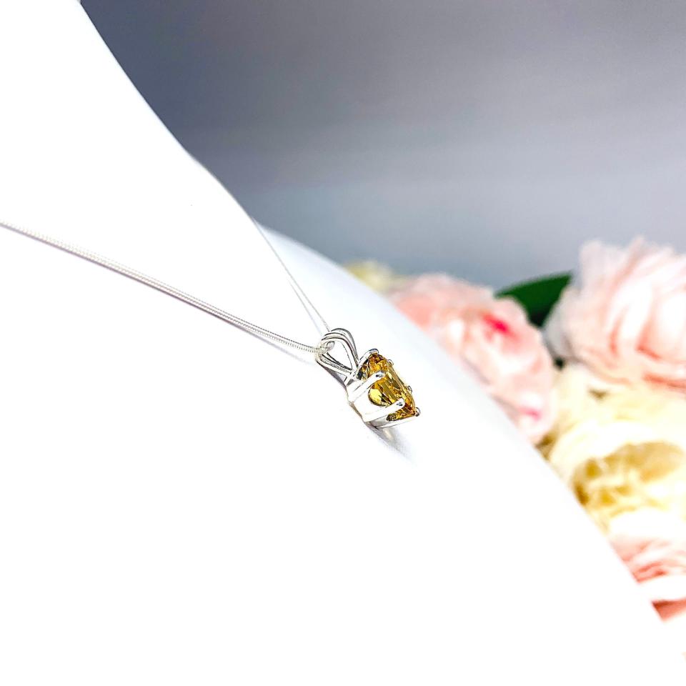Sterling silver necklace with a 10x8mm oval-cut golden citrine pendant in a 6-prong setting, displayed against a white background.