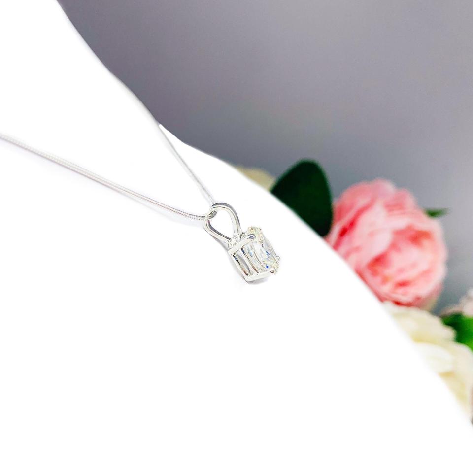 Sterling silver necklace featuring an oval near-colorless cubic zirconia pendant in a four-prong setting with single bail, shown on a sterling silver chain.