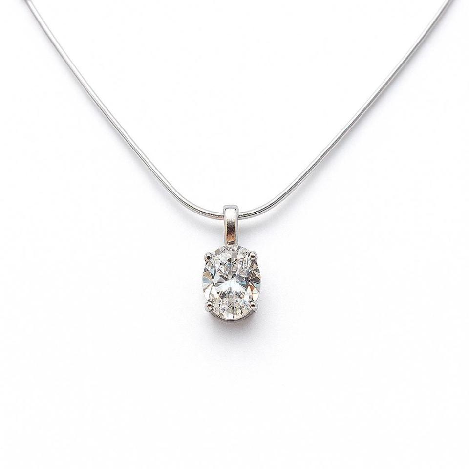 Sterling silver necklace featuring an oval near-colorless cubic zirconia pendant in a four-prong setting with single bail, shown on a sterling silver chain.