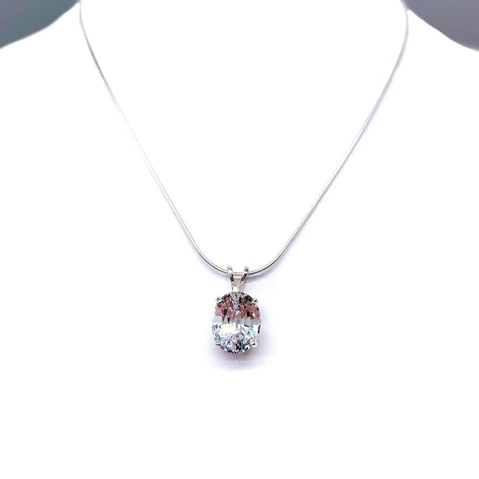 Sterling silver necklace featuring an oval lab-created white sapphire pendant in a 4-prong setting, available in four sizes.