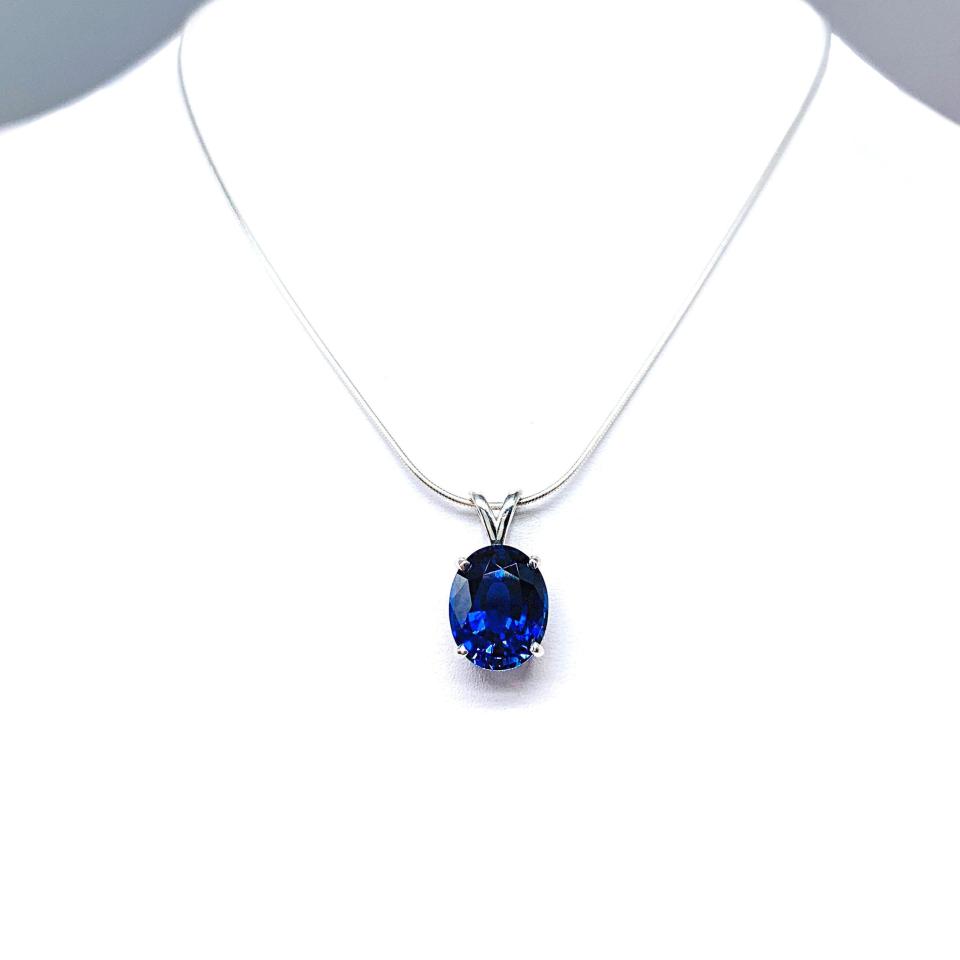Sterling silver necklace featuring an oval lab-created blue sapphire pendant in a 4-prong setting, available in six sizes.