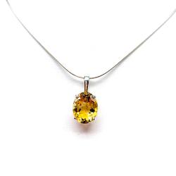 A sterling silver necklace with a pendant featuring a 12x10mm oval-cut, golden citrine gemstone. The necklace is resting against a white background.