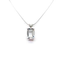 Close-up of an emerald-cut white topaz pendant necklace featuring a faceted natural gemstone in a sterling silver prong setting, suspended from a delicate sterling chain. Available in four stone sizes.
